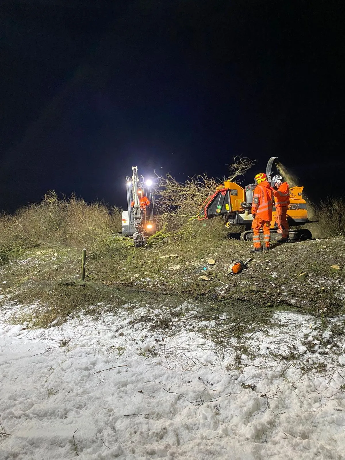 Chipper processing cleared vegetation alongside the M65 carriageway