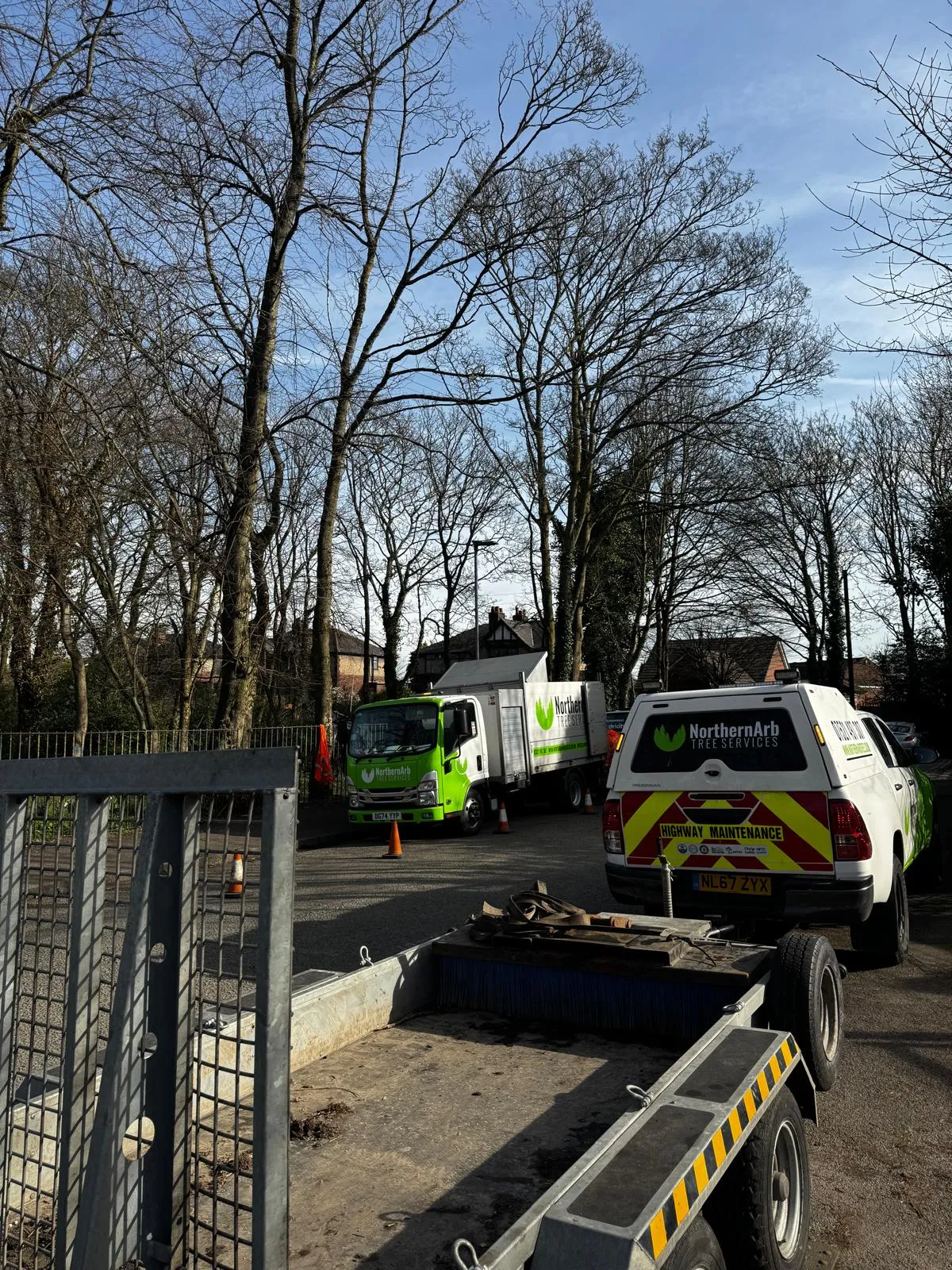 Chipper truck and crew clearing trees at Wigan park